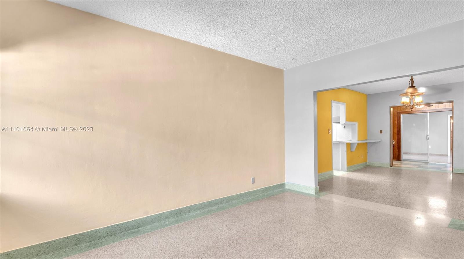 3333 Southwest 1st Street Miami, FL 33135 - Photo 15 of 70 a view of a room with a stylish ceiling window and chandelier