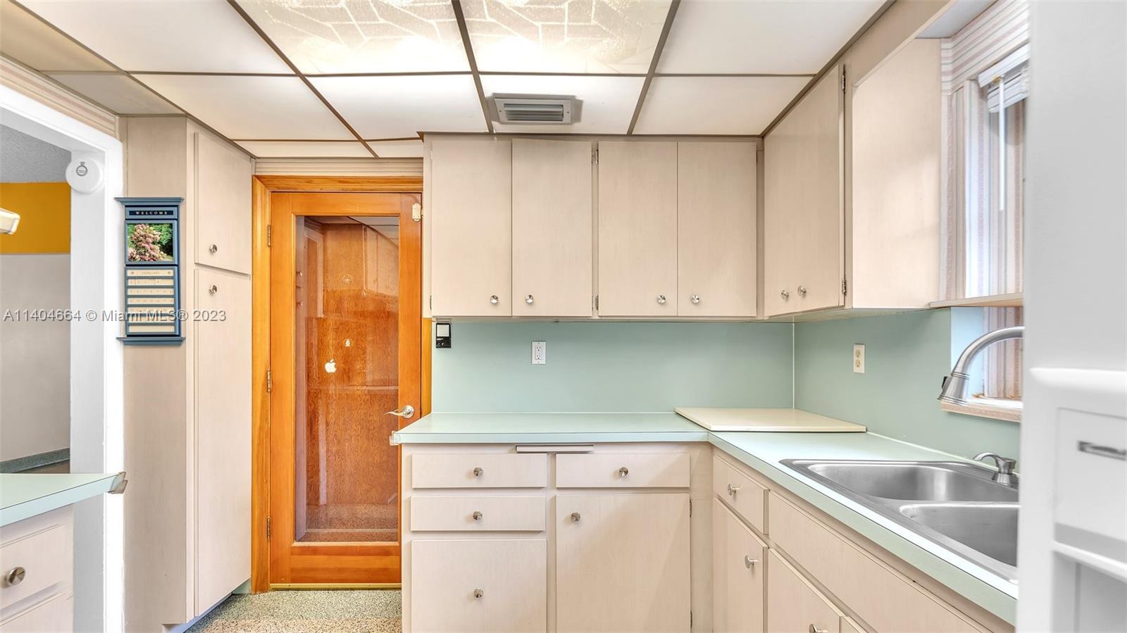 3333 Southwest 1st Street Miami, FL 33135 - Photo 43 of 70 a kitchen with white cabinets and sink