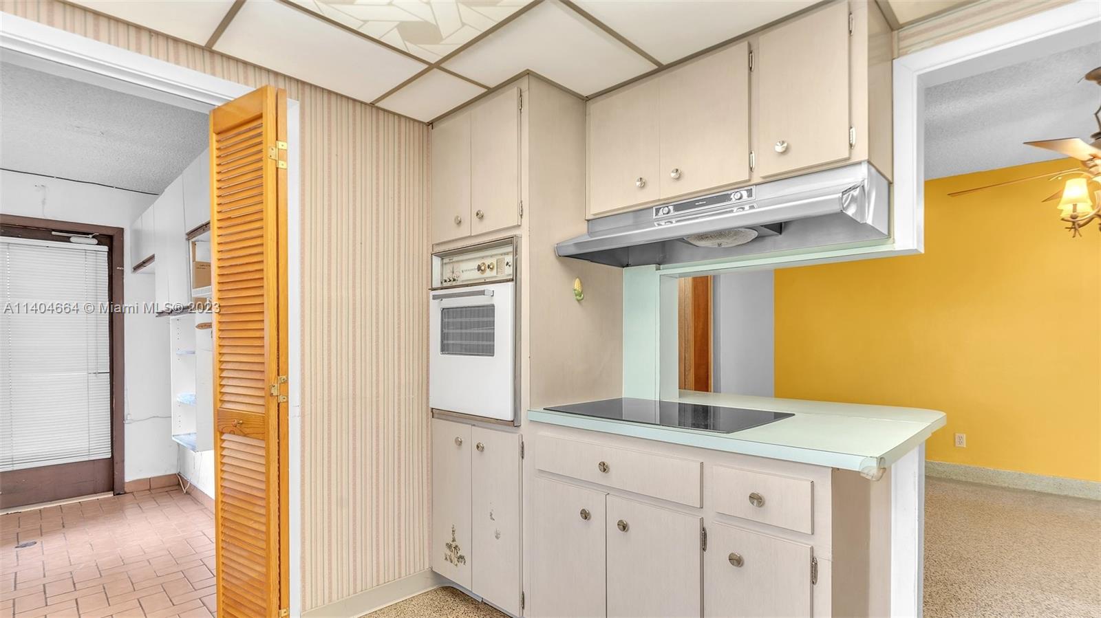 3333 Southwest 1st Street Miami, FL 33135 - Photo 48 of 70 a kitchen with stainless steel appliances granite countertop a sink and cabinets