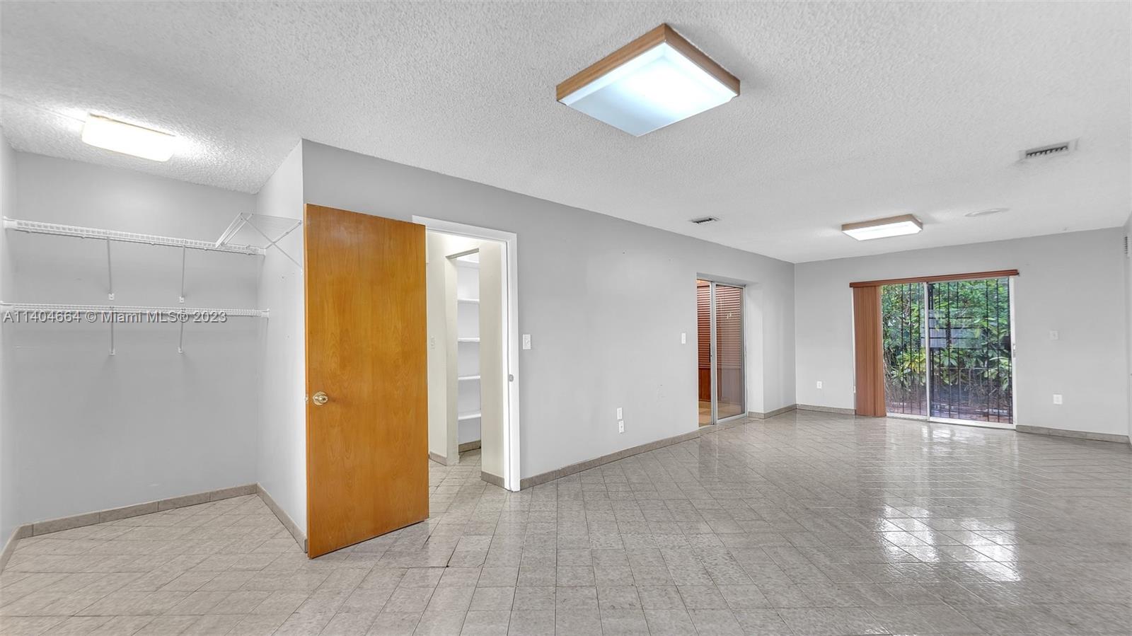 3333 Southwest 1st Street Miami, FL 33135 - Photo 5 of 70 an empty room with windows and closet