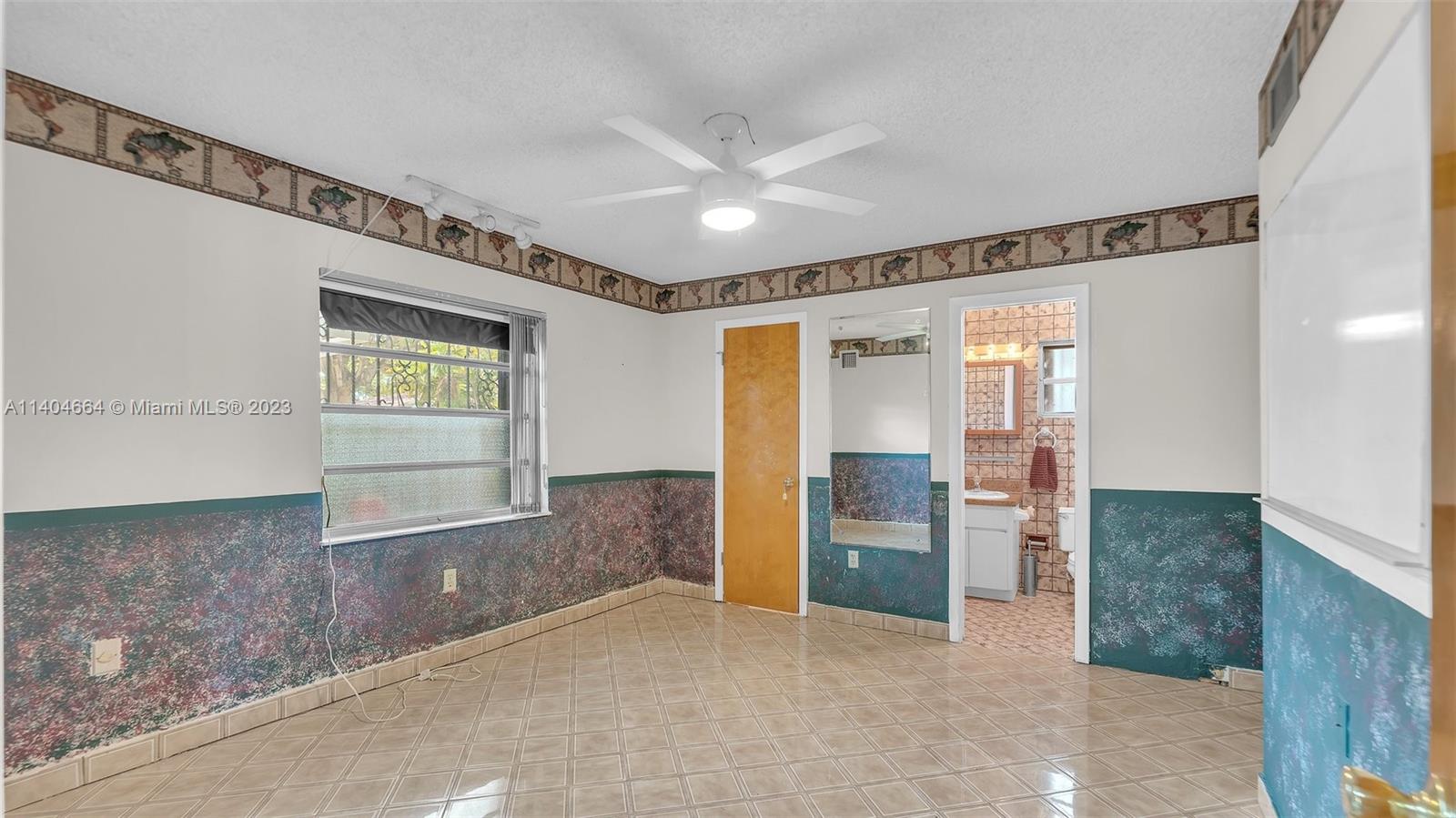 3333 Southwest 1st Street Miami, FL 33135 - Photo 6 of 70 wooden floor in an empty room with a window
