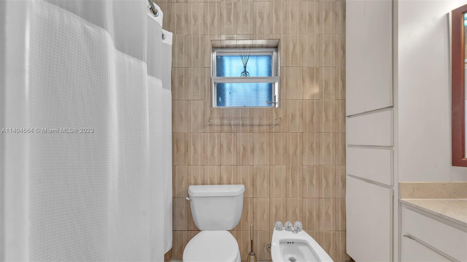 3333 Southwest 1st Street Miami, FL 33135 - Photo 8 of 70 a white toilet sitting next to a white sink