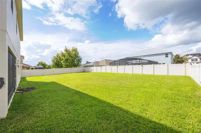 a dining area with a table chairs and a kitchen view