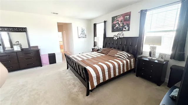 a view of a hallway with furniture and a window