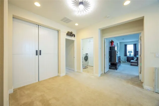 a bedroom with a bed a window and a couch