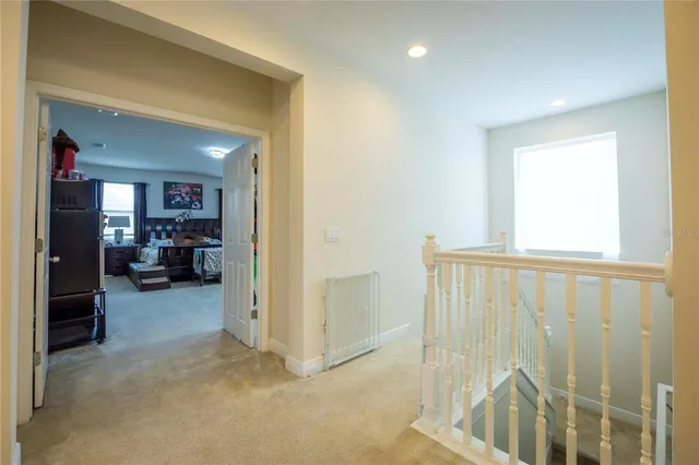 a dining room with furniture and a floor to ceiling window