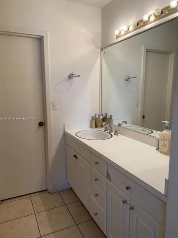 a spacious bathroom with a double vanity sink mirror and toilet