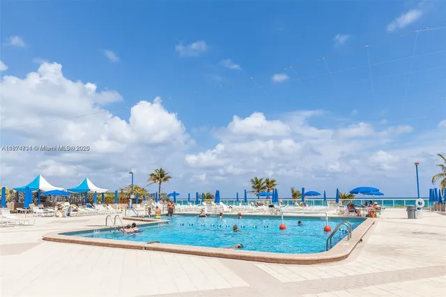 a view of a swimming pool with a yard