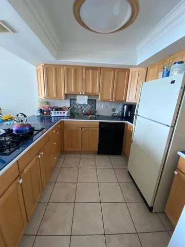 a kitchen with a sink a refrigerator and dishwasher