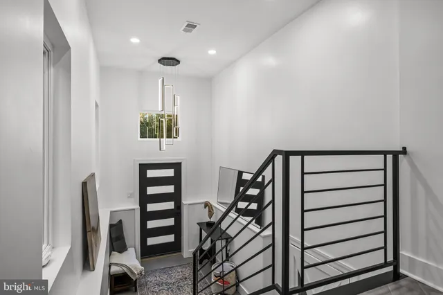 a living room with furniture a window and a flat screen tv