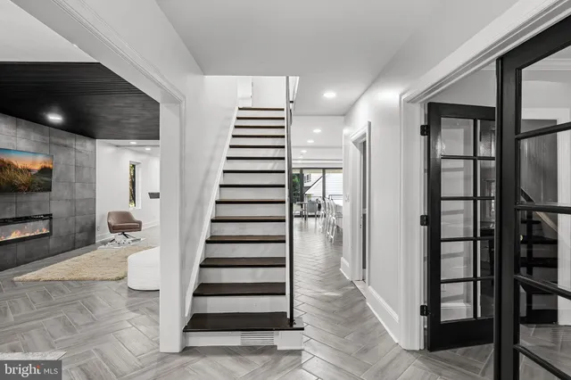 a spacious bedroom with a bed and glass wall