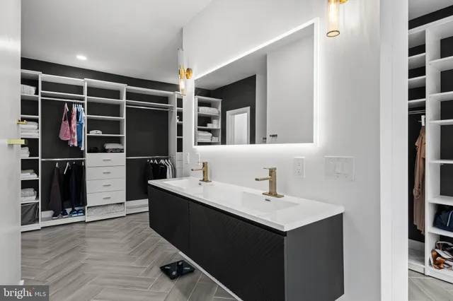 a view of walk in closet with clothes and shoes