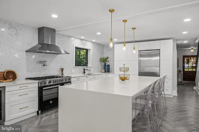 a kitchen with a stove a refrigerator and a wooden floor