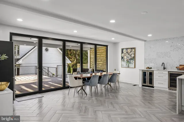a living room with furniture and large windows
