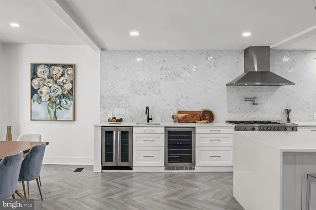 a large white kitchen with a large window