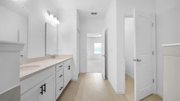 a spacious bathroom with a granite countertop sink mirror and a shower