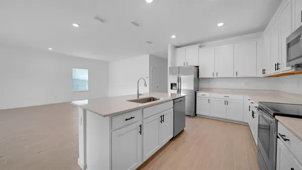 a kitchen with a sink stove and cabinets