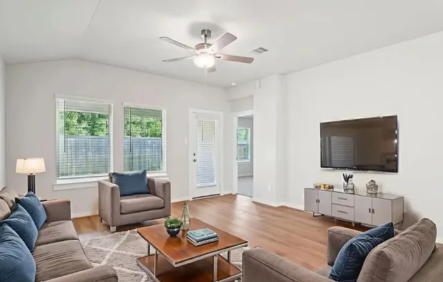 a living room with furniture and a flat screen tv