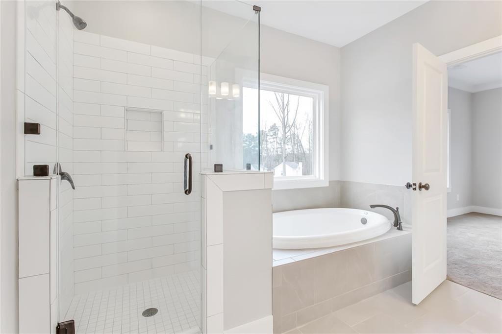 3 Pope Road Buchanan, GA 30113 - Photo 7 of 11 a bathroom with a bathtub a window and a shower