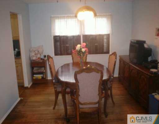 13 Meyer Road Edison, NJ 08817 - Photo 6 of 8 a view of a dining room with furniture and wooden floor