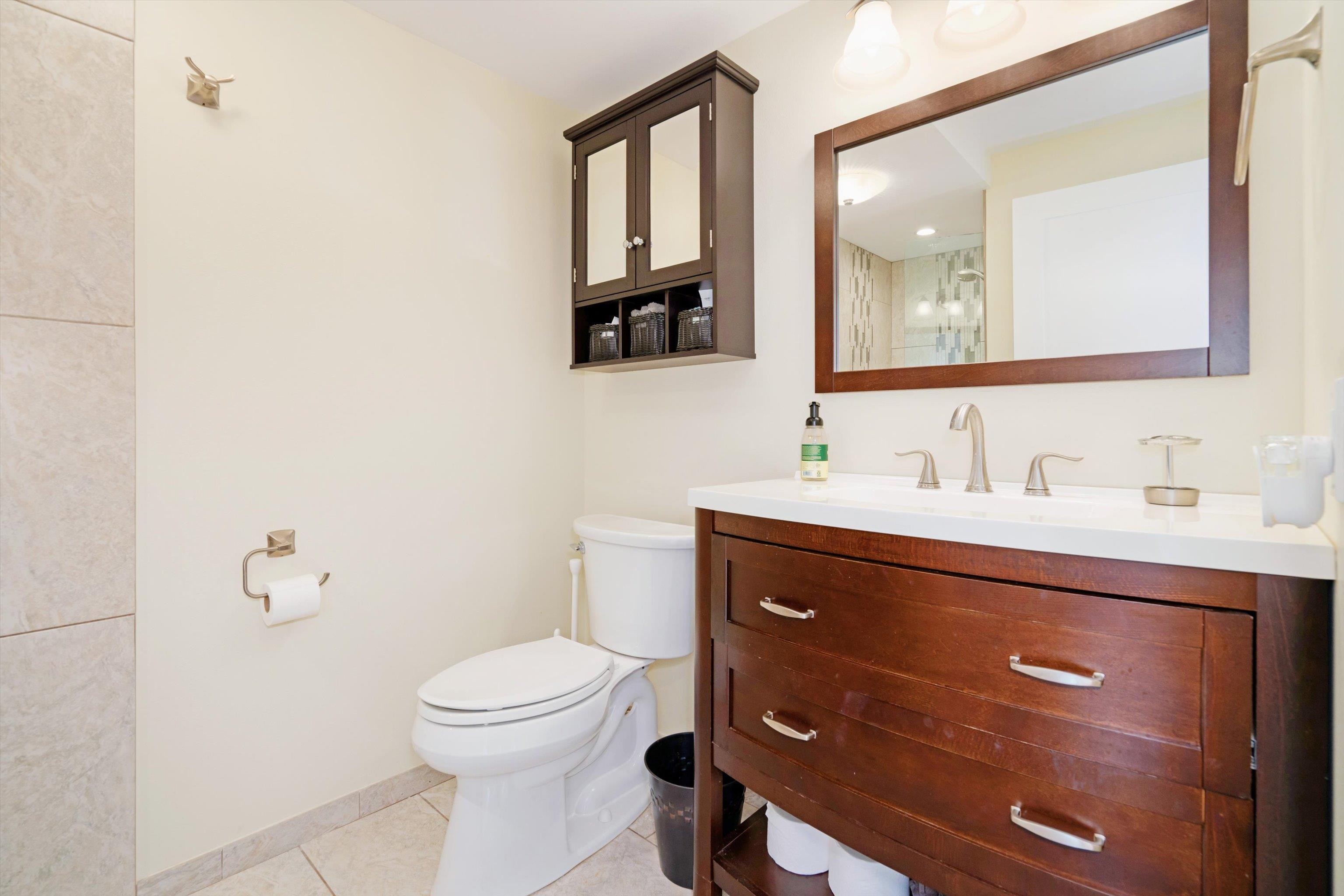 2747 South Kihei Road, Unit B203 Kihei, HI 96753 - Photo 13 of 44 a bathroom with a toilet a sink a mirror and a window