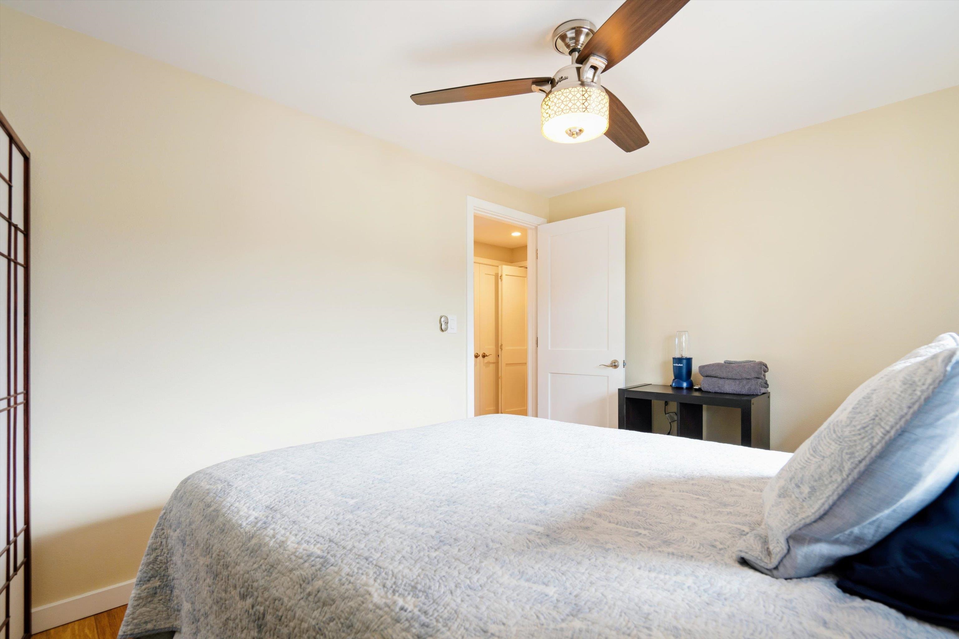 2747 South Kihei Road, Unit B203 Kihei, HI 96753 - Photo 16 of 44 a bedroom with a bed and a chandelier