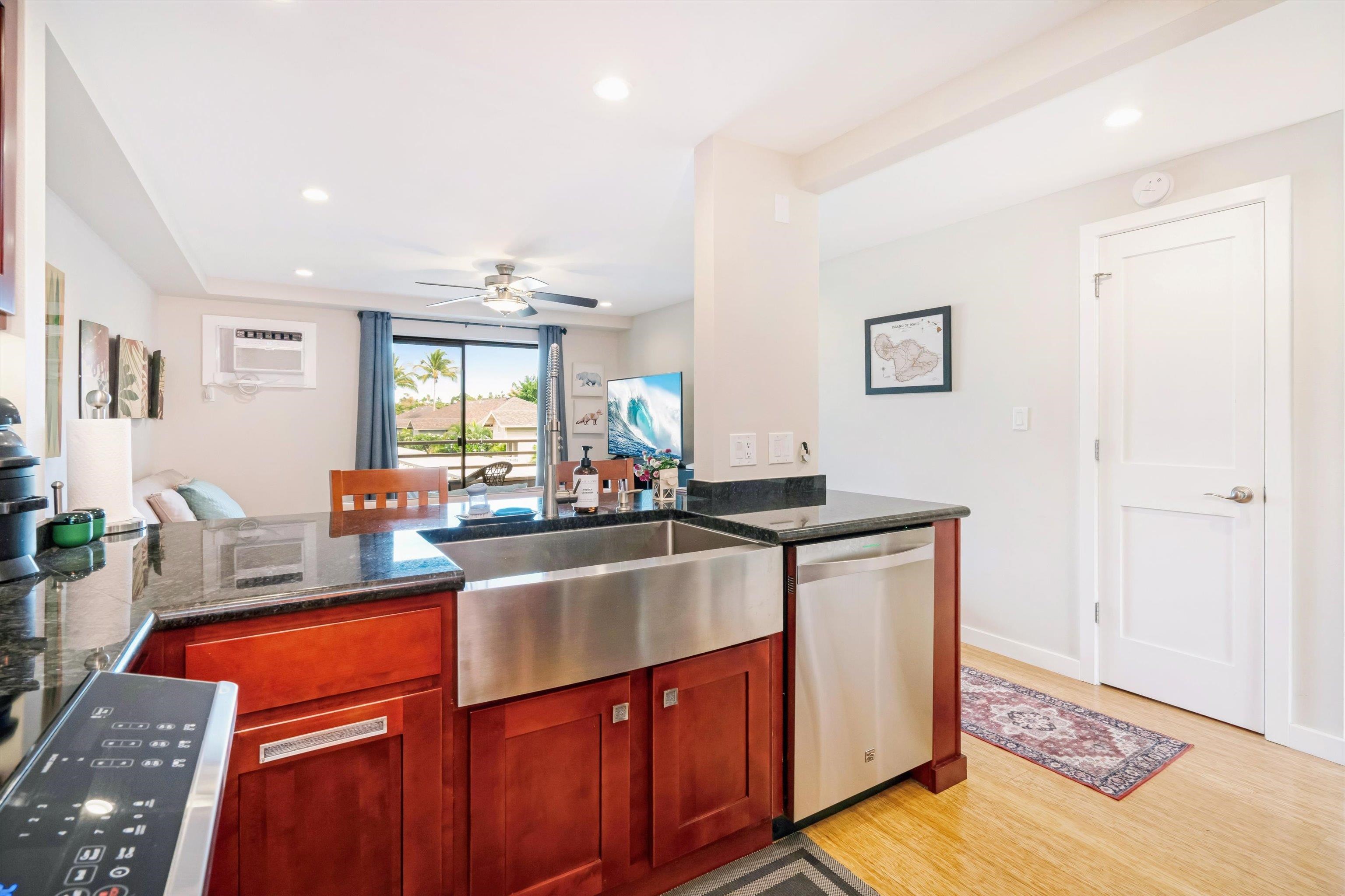 2747 South Kihei Road, Unit B203 Kihei, HI 96753 - Photo 22 of 44 a kitchen with stainless steel appliances granite countertop a sink stove and cabinets