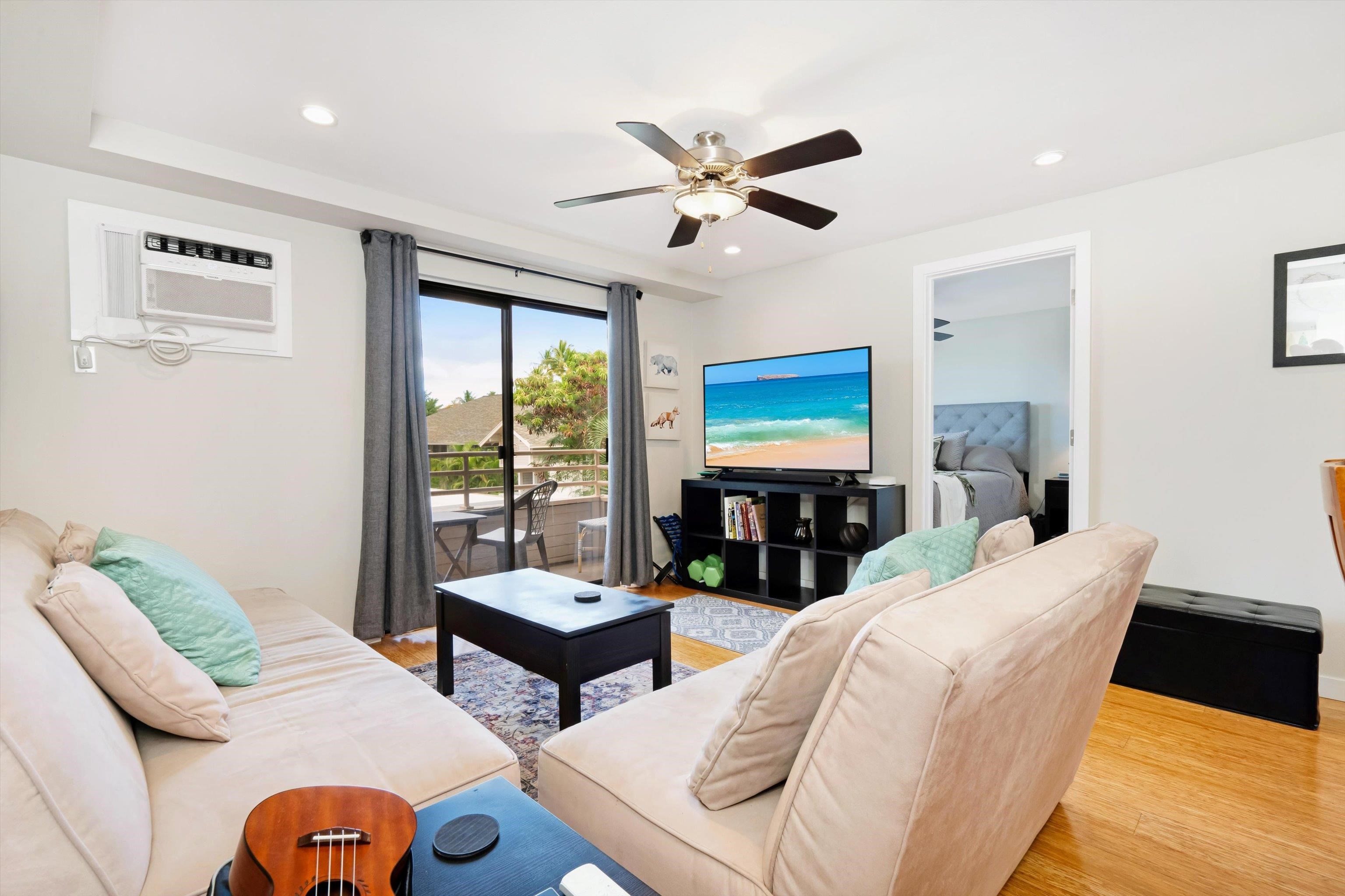 2747 South Kihei Road, Unit B203 Kihei, HI 96753 - Photo 27 of 44 a living room with furniture a ceiling fan and a large window