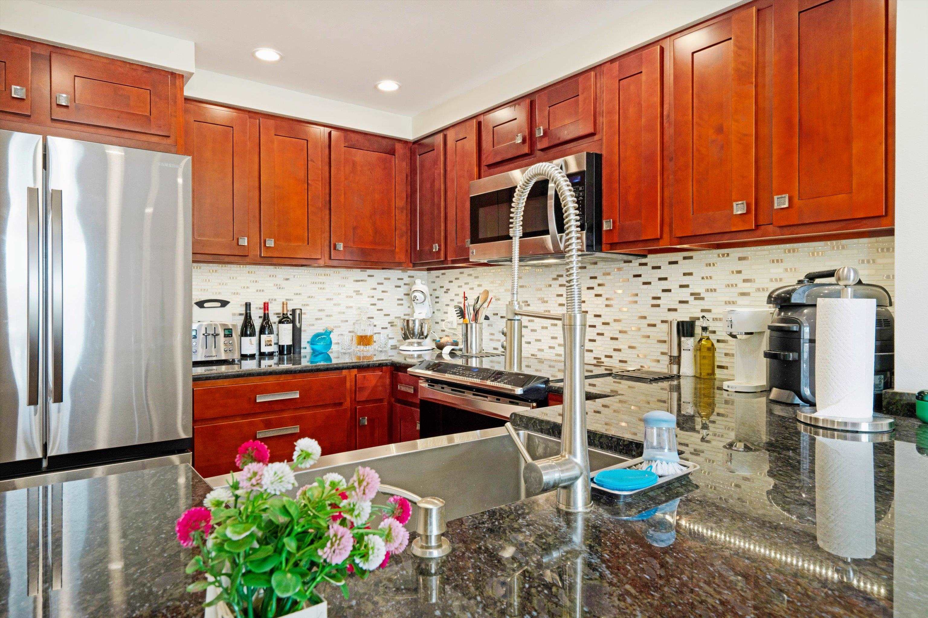 2747 South Kihei Road, Unit B203 Kihei, HI 96753 - Photo 4 of 44 a kitchen with stainless steel appliances granite countertop a refrigerator sink and cabinets