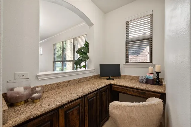 a kitchen with granite countertop a sink a counter top space and cabinets