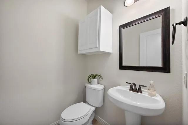 a bathroom with a sink a mirror and a toilet