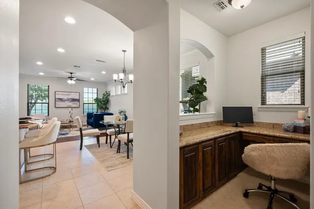 a dining hall with stainless steel appliances kitchen island granite countertop furniture and a kitchen view