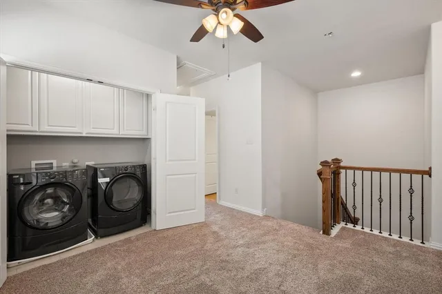 a view of a hallway with washer and dryer