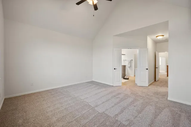 a view of an empty room with a ceiling fan