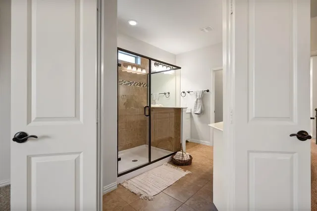 a bathroom with a shower and closet