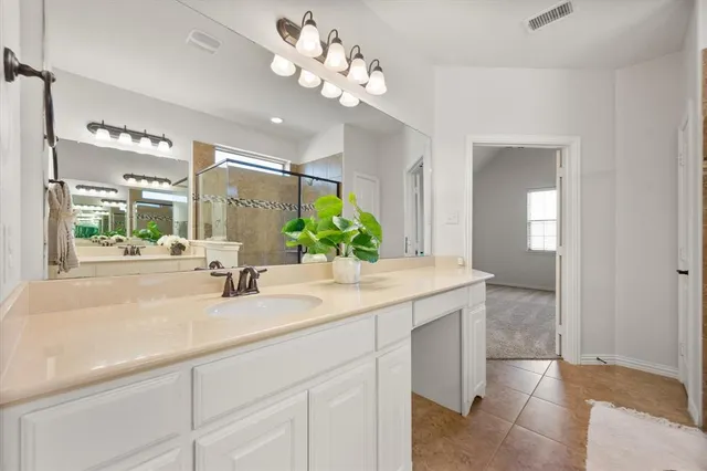 a bathroom with a sink vanity and a mirror