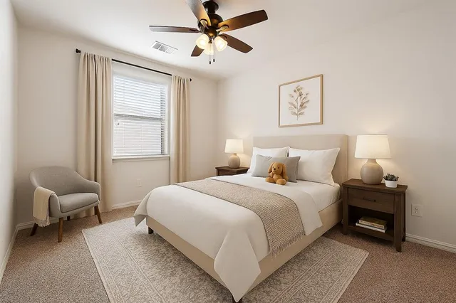 a bedroom with a bed and a chair