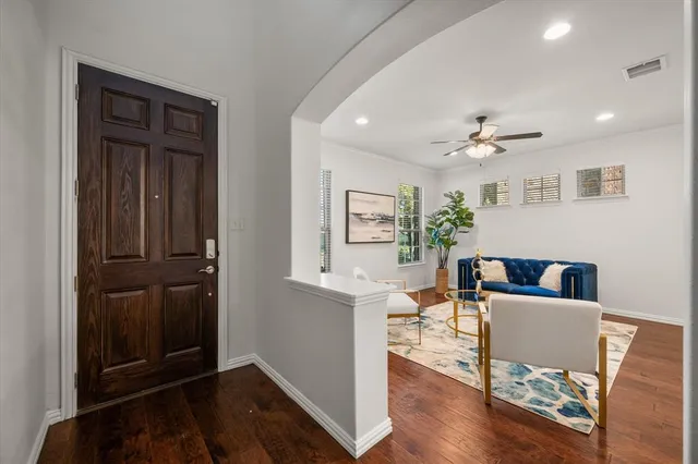 a living room with furniture and wooden floor