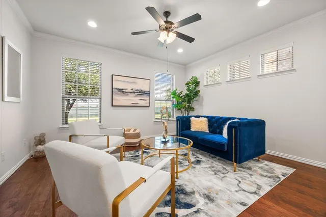 a living room with furniture ceiling fan and a window