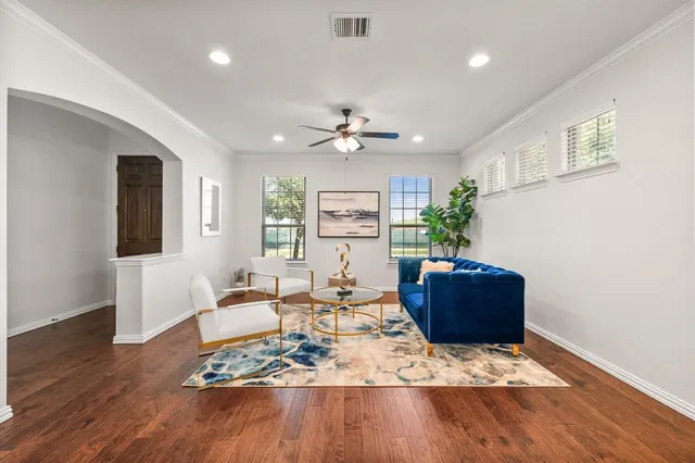 a living room with furniture and wooden floor
