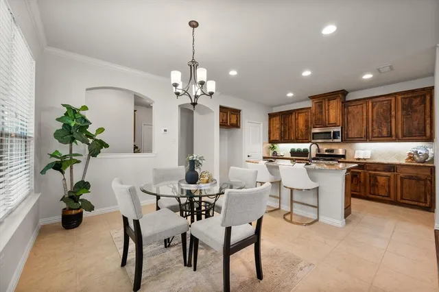 a kitchen with a refrigerator and a dining table