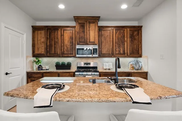 a kitchen with a stove and a refrigerator