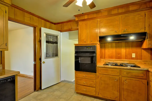 a kitchen with stainless steel appliances granite countertop a refrigerator and a stove