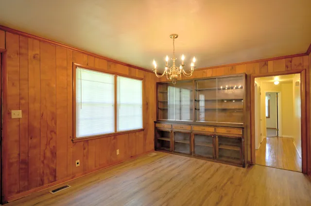 a view of a room with wooden floor and windows