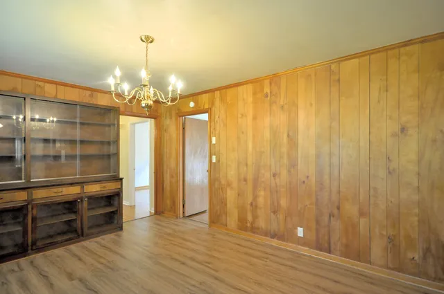 a view of a room with wooden floor and staircase