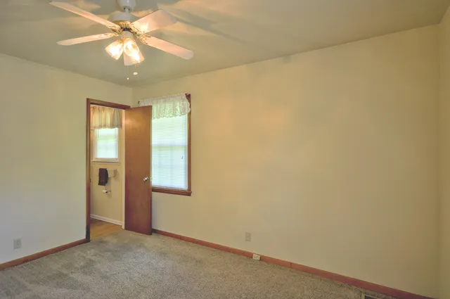 an empty room with a empty space and a ceiling fan