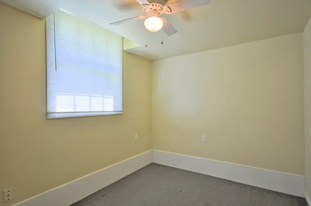 a view of a small space with a wooden floor and a window