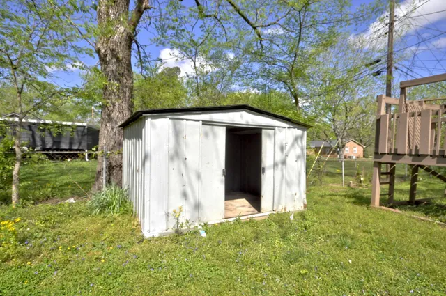a view of backyard of house with green space