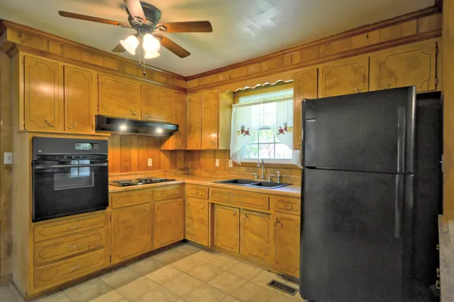 a kitchen with a refrigerator and a sink