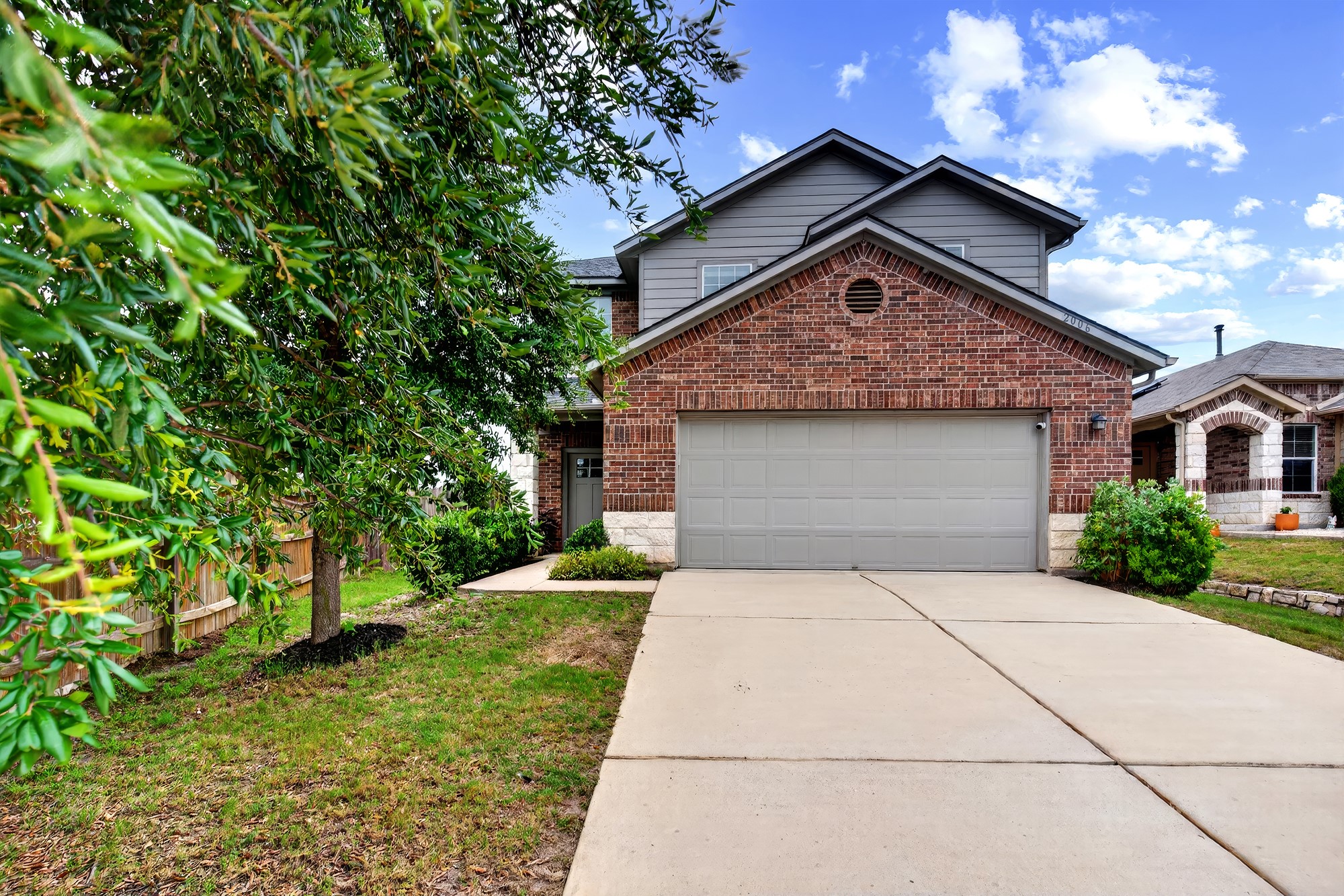 2006 Grow Lane Austin, TX 78754 - Photo 1 of 40 A classic brick and siding two-story residence with an integrated garage and concrete driveway.